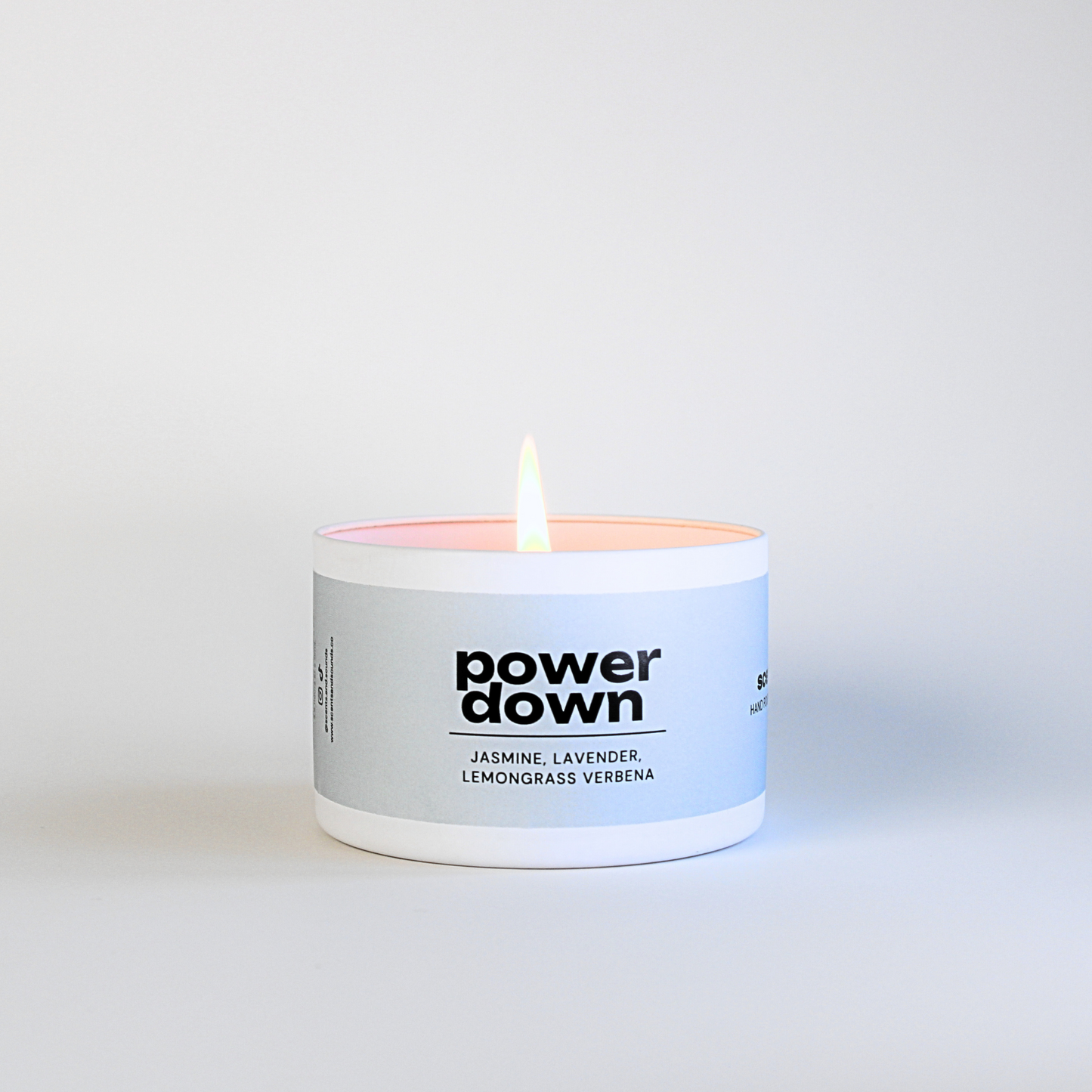 Close-up of the Power Down Candle by Scents & Sounds, featuring elegant label design with jasmine, lavender, lemongrass verbena scent description.